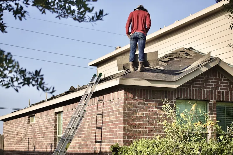 Professional roofer working on a residential roof in 45th and Moncrief